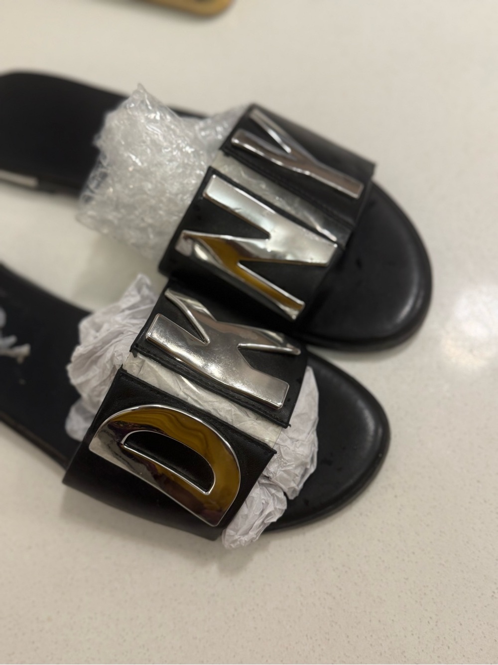 DKNY Black Slide Sandals with Silver Letter Accents